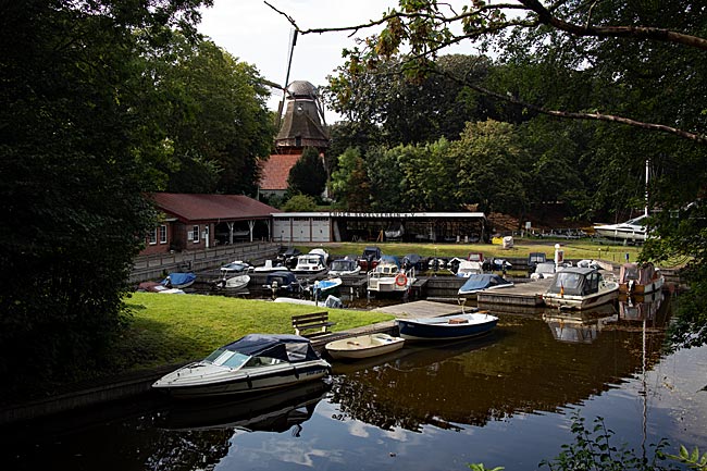 Emden in East Frisia - A section of the city moat with leisure boats and the windmill De Vrouw Johanna, which was built in 1804/05 on the city wall, Emden's former defensive structure.