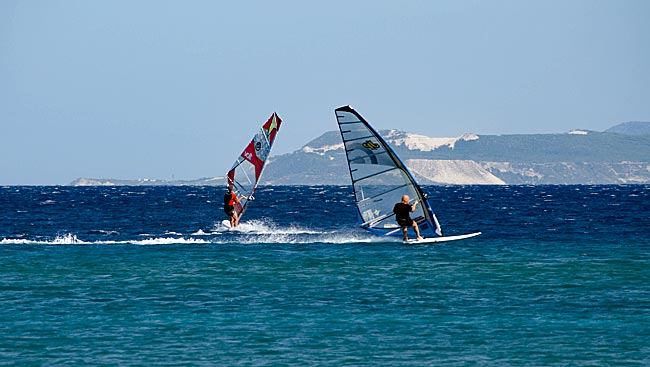 Kos in Greece - They’ve got it down — surfers further out in the bay.