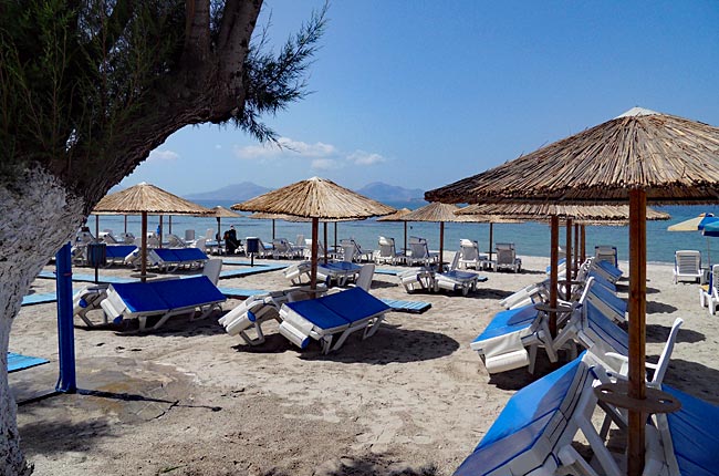 Kos in Greece - Marmari - Main beach with rental loungers and umbrellas; drinks and snacks served just behind