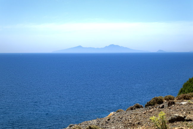 Greece - Kos - View of Nisyros from above the Embros Spa on Kos. Clearly visible - or rather, not so clearly - is the blasted cone of the volcano