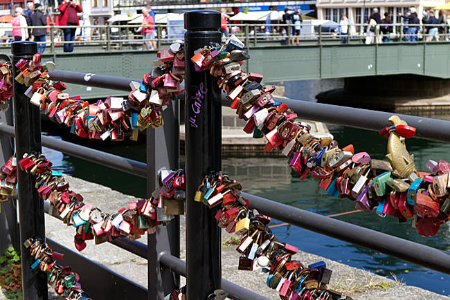 Rostock - Warnemünde - Numerous love locks attached to a railing next to the bridge.
