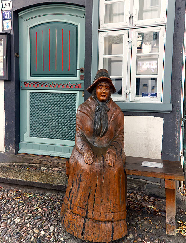 Rostock - Warnemünde - In front of the local history museum stands the sculpture Die Warnemünderin, created in 2016/17 by Rostock woodcarver Harald Wroost from the timber of a 200-year-old oak tree from the Rostocker Heide